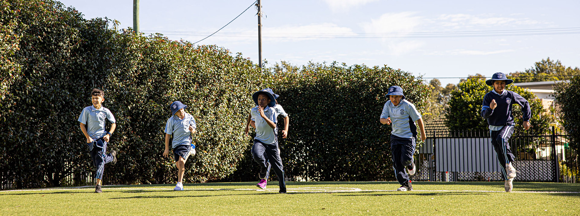 Holy Trinity Catholic Primary School Granville students running on lawn