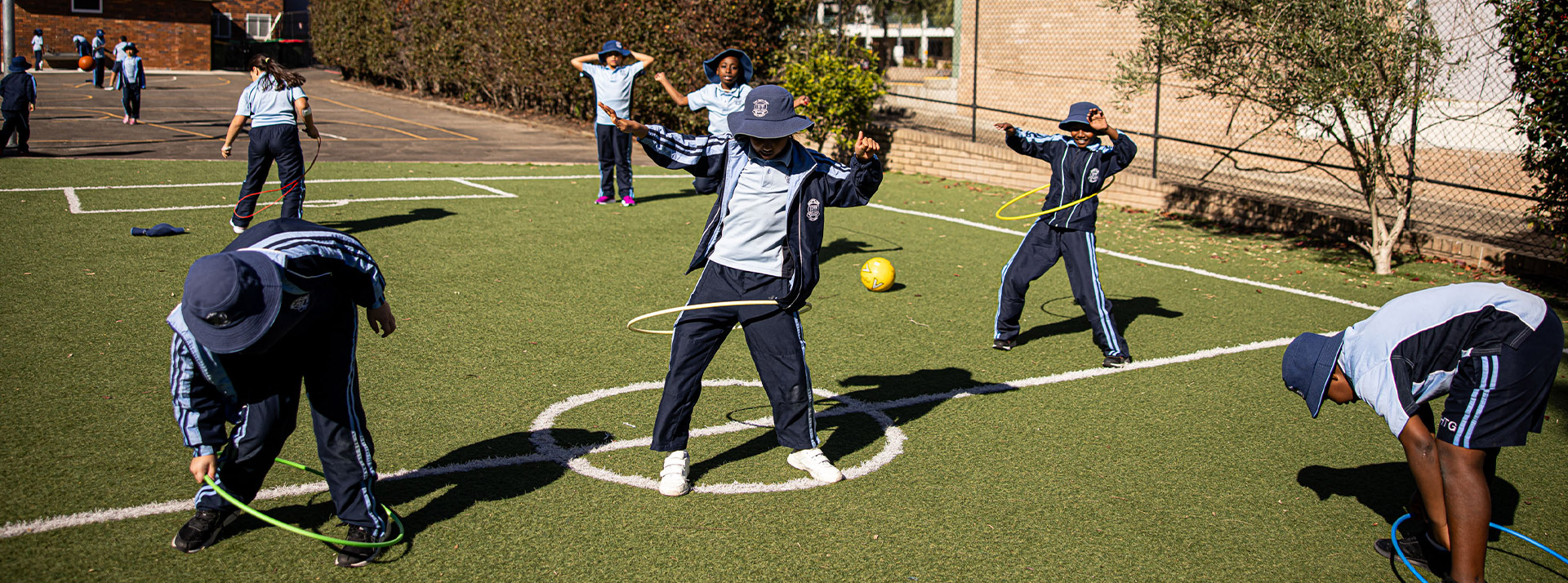Holy Trinity Catholic Primary School Granville students in playground with hoola hoops
