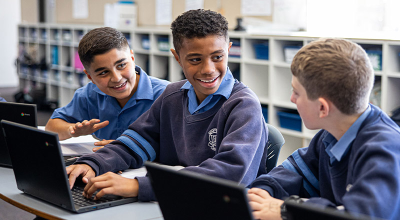 Holy Trinity Catholic Primary School Granville students laughing over laptops