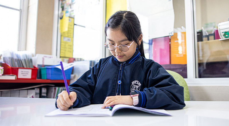 Holy Trinity Catholic Primary School Granville student sitting at desk