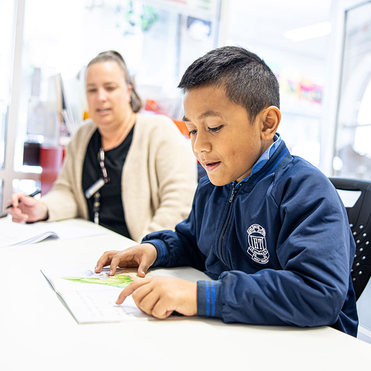 Teacher supporting student at Holy Trinity Primary Granville